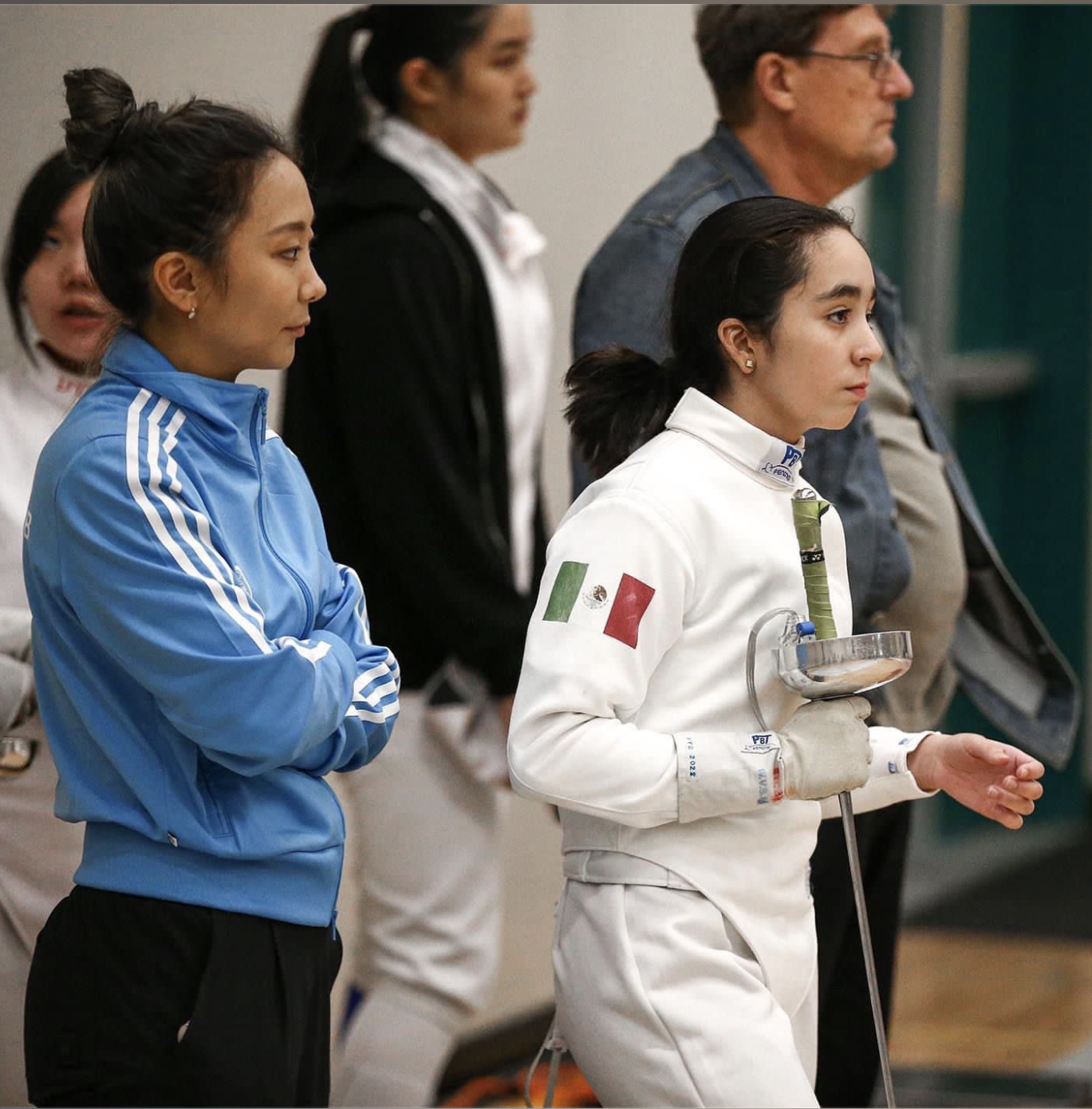 Rivera and her former coach Julie Shin watch Rivera's next opponent like a hawk. Their intent observation and strategizing allow Rivera to win the next match. Photo courtesy of Azul Rivera.
